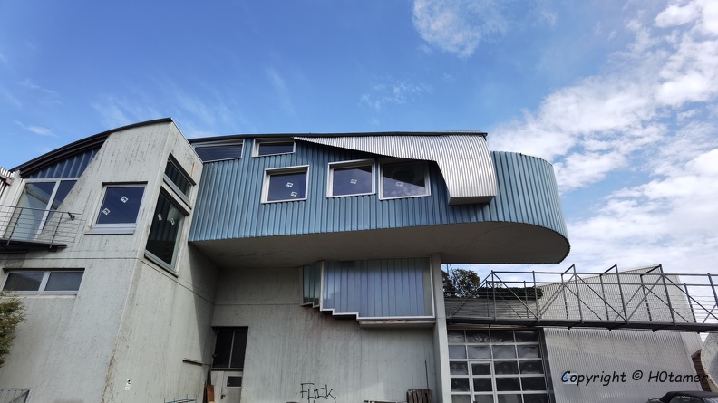 Our neighbouring village has some kind of construction firm with a very interesting main building.
It is made of different materials, the roof partly looks like a duck tail, the walls are straight or round, etc. A real eye-catcher. H0tamer_20210428.jpg